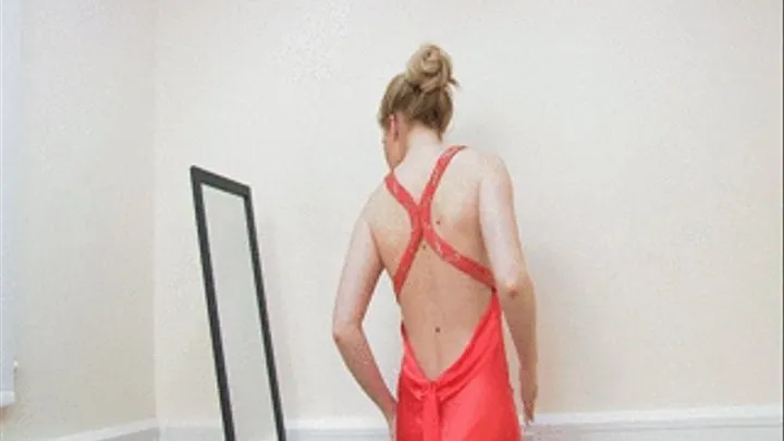 SU458 Leona makes for the perfect "Lady in Red" as she poses in her long red satin evening dress and knowing we are desperate to know what panties she has on beneath it, she slowly starts lifting her skirt to reveal