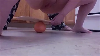 Under A Cutting Board Squeezing A Grapefruit
