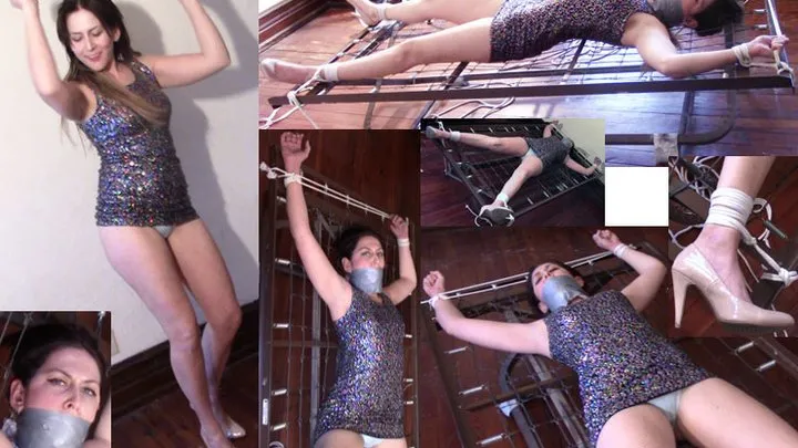 Long legged party girl big gagged and tied spread eagle on steel bedframe