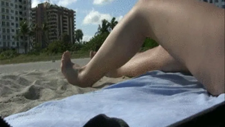 Calves Flexing Toe Point Tanning at the beach