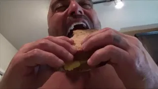 Giant eats sandwich