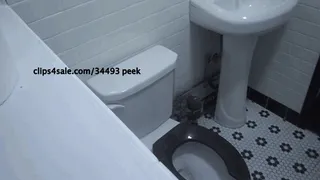 PUBLIC PEE IN BLACK AND WHITE BATHROOM W A BLACK TOILET SEAT