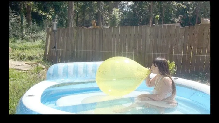 Galas Blow to Pop Yellow Balloon in Inflatable Pool