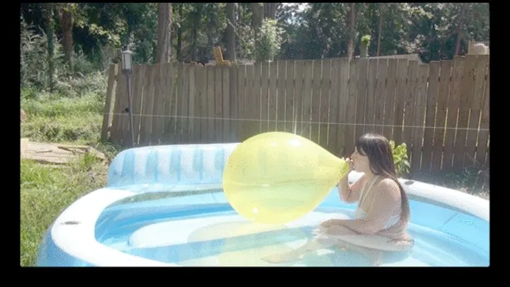 Galas Blow to Pop Yellow Balloon in Inflatable Pool