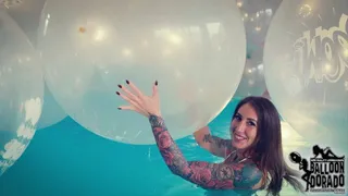 Megan pops a lot of 40 Inch Boom Balloons with her Fingernails in the Pool