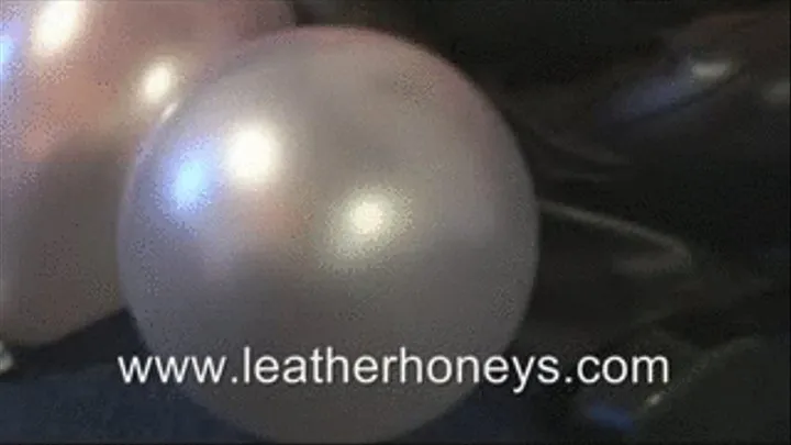 Busty Babe Blowing Up Balloons in Latex Dress