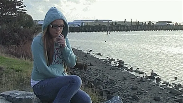 Ashley smokes by the water