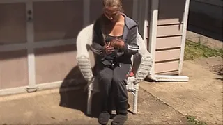 Ashley smokes outside her house