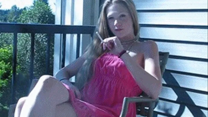 Chelsea smokes outside on her balcony