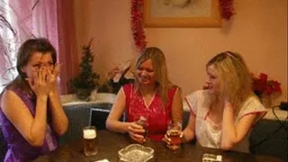 3 girls in smoks sit in kitchen