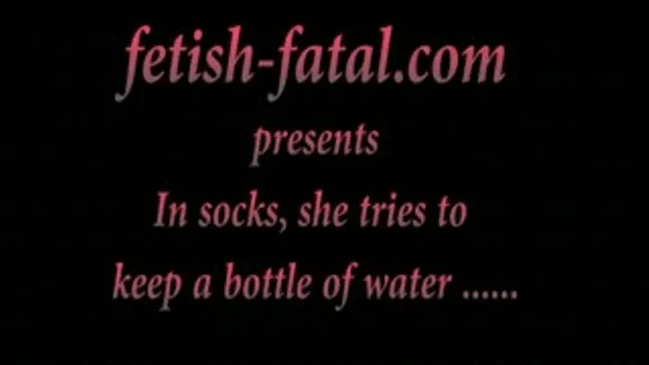 In socks, she tries to keep a bottle of water ............En chaussettes, elle essaye de tenir une bouteille d'eau ......