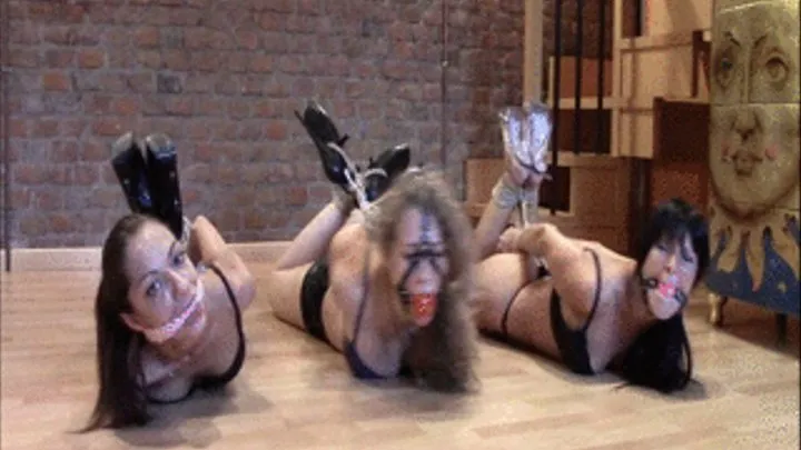 Three girls hogtied on the floor