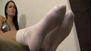 Mistress Nikki presses her smelly white socks on the face of her slave and makes him worship on them