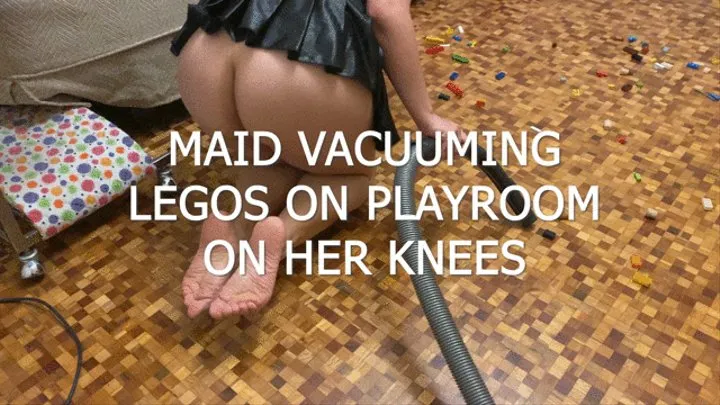 MAID VACUUMING LEGOS ON PLAYROOM ON HER KNEES WITH WRINKLED SOLES