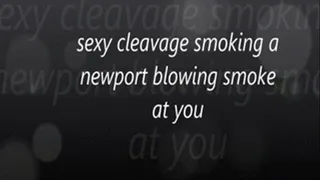 sexy cleavage smoking a newport blowing smoke at you