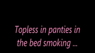 Topless in panties in the bed smoking ...