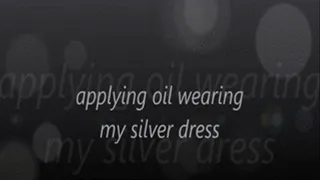 applying oil wearing my silver dress