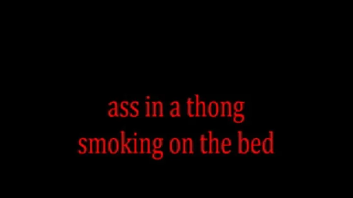 ass in a thong smoking on the bed