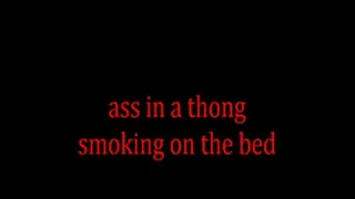 ass in a thong smoking on the bed