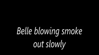 Belle blowing smoke out slowly
