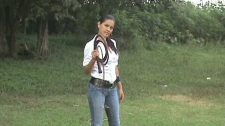 Diosa playing with her bullwhip outdoors