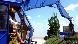 Nice pedaling Secretary sits in a antique gripping excavator (Flow-Picture-Show)