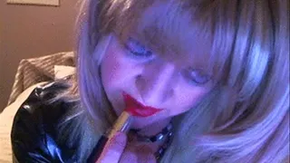 Mistress applies red lipstick