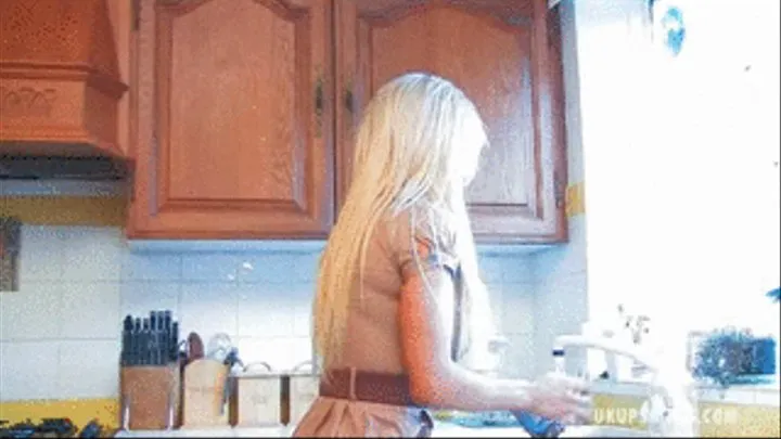 UKU Luara M is working away in her kitchen unaware we are peeping up her skirt at her panties - Mpeg