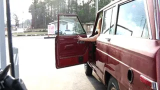 Cassandra Gassing Up the Jeep in Brown Knee High Boots & Black Dress