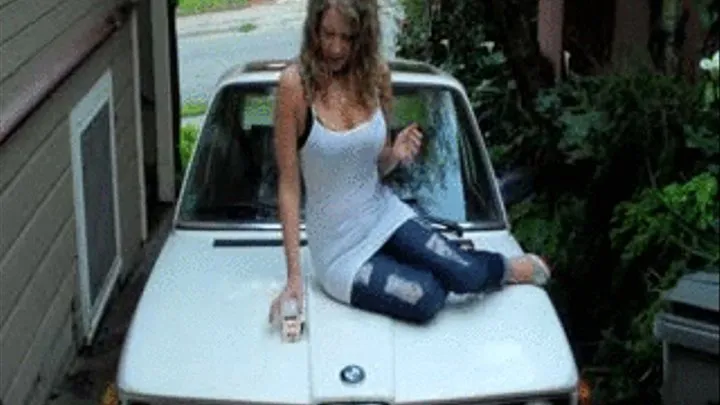 Blonde Smokes Camel Filters On Hood Of BMW