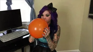 Kandy blows up balloons at work