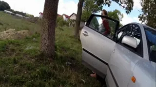 ( ) Pissing in the grass and playing with her pussy in the car