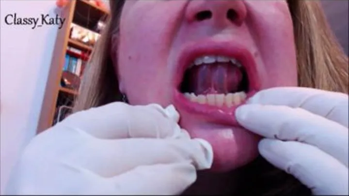 Mouth exploration in medical gloves, close-up.