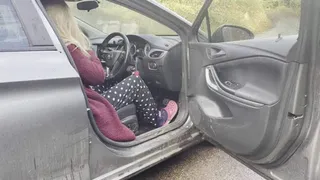 Jess revving and warming up the car with pink crocks