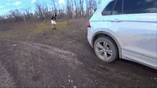 L O R Y pushes a car stuck in the mud b