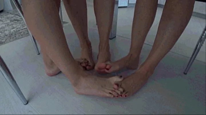 3 girls barefoot sitting at a table interlocking their toes b