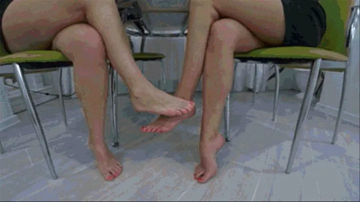 flirting bare feet under the table of two girls b