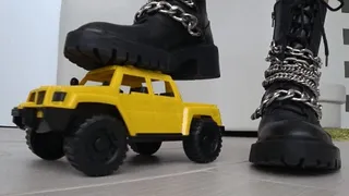 Crushed a toy car with black boots c