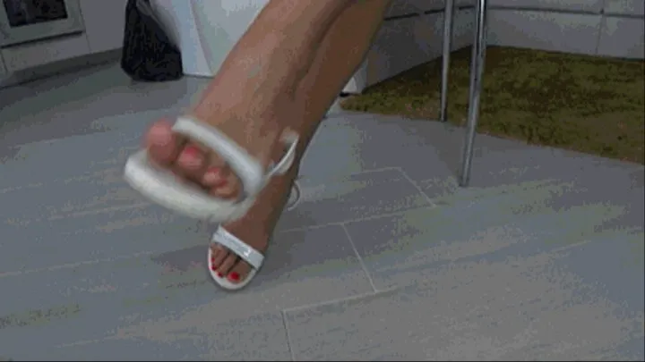 Dangling and toe wiggling in white summer sandals c