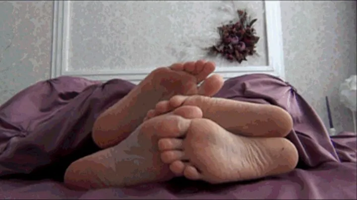 Flirting feet under a blanket of two lesbians d