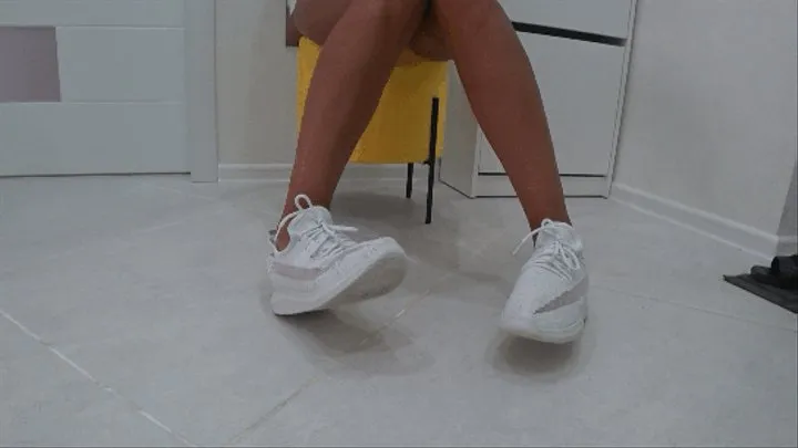 toe wiggling in white soft sneakers a