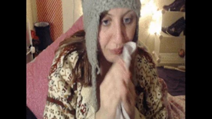 Sneezing and nose blowing in unbuttoned cardy and hat