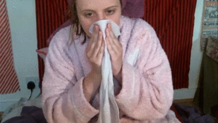 Nose blowing in towel and robe