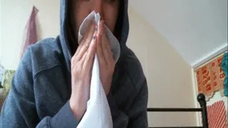 Handkerchief nose blowing and sneezing in hoodie