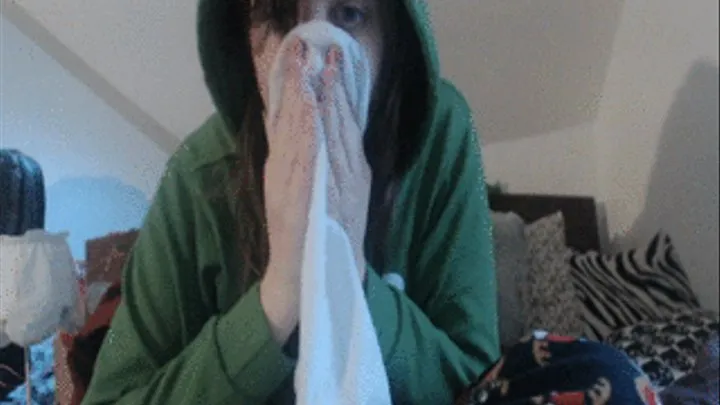 Blowing nose into hanky green hoodie