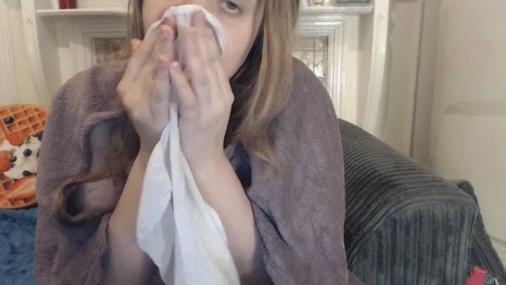 Nose blowing naked under a blanket