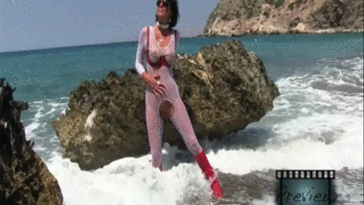 Nanalou in latex red bra and a red bud plug in her ass at the beach