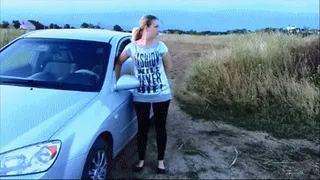 Blonde riding on the car and pushes it out of MUD