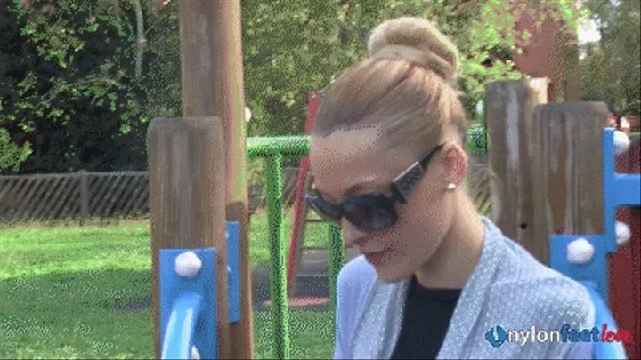 A sexy blondie Christelle massaging her hosed feet on a playground HQ