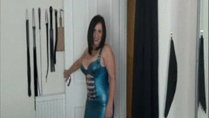 MISTRESS SHOWS YOU AROUND HER DUNGEON IN A VERY TIGHT BLUE LATEX DRESS.